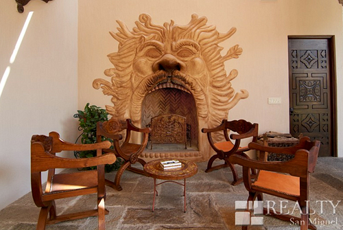 40 Fuentes - Tuscan style fireplace with Neptune carved in relief around the fireplace facade