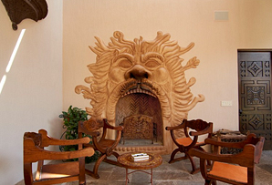 40 Fuentes - Tuscan style fireplace with featuring Neptune and his mouth of fire